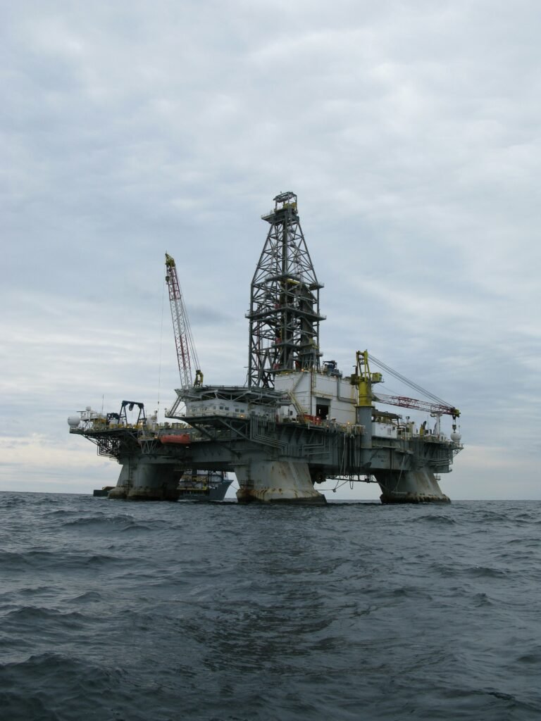 Offshore oil rig operating in open water under a cloudy sky