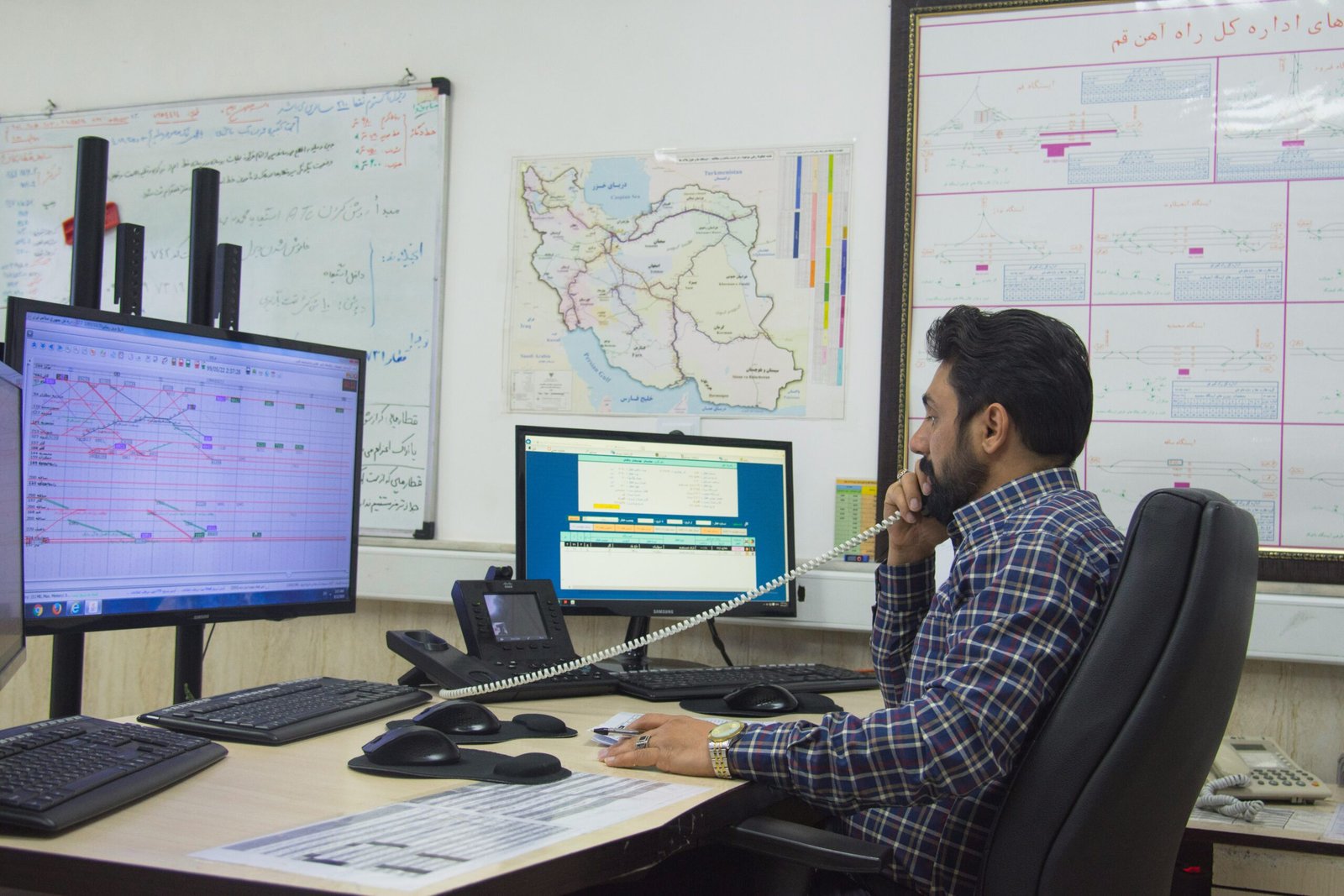 Telecommunications officer monitoring communication systems and network operations from a control center.