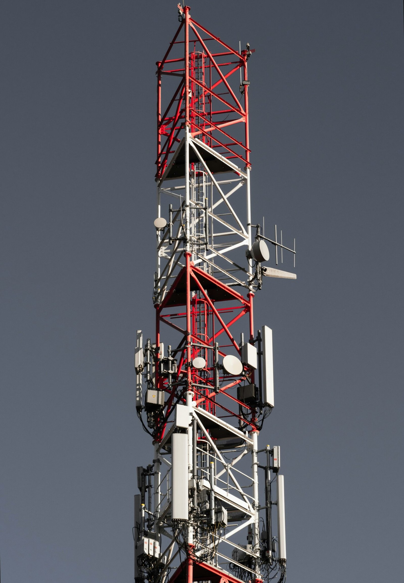 Modern cellular telecommunications tower equipped with antennas and wireless communication infrastructure.